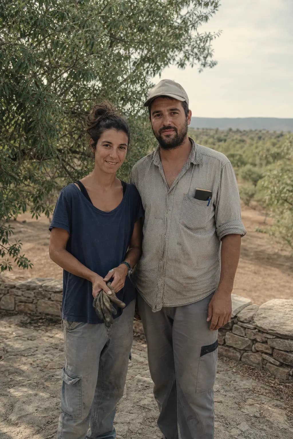 Elena and Sergio on an almond terrace on their farm in La Codoñera