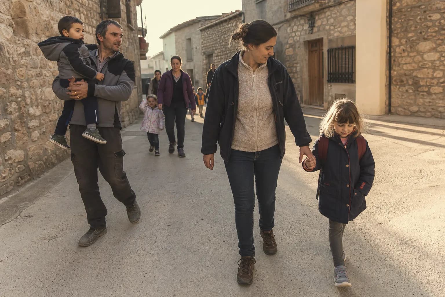 Elena walks her elder child to the village school in La Codoñera