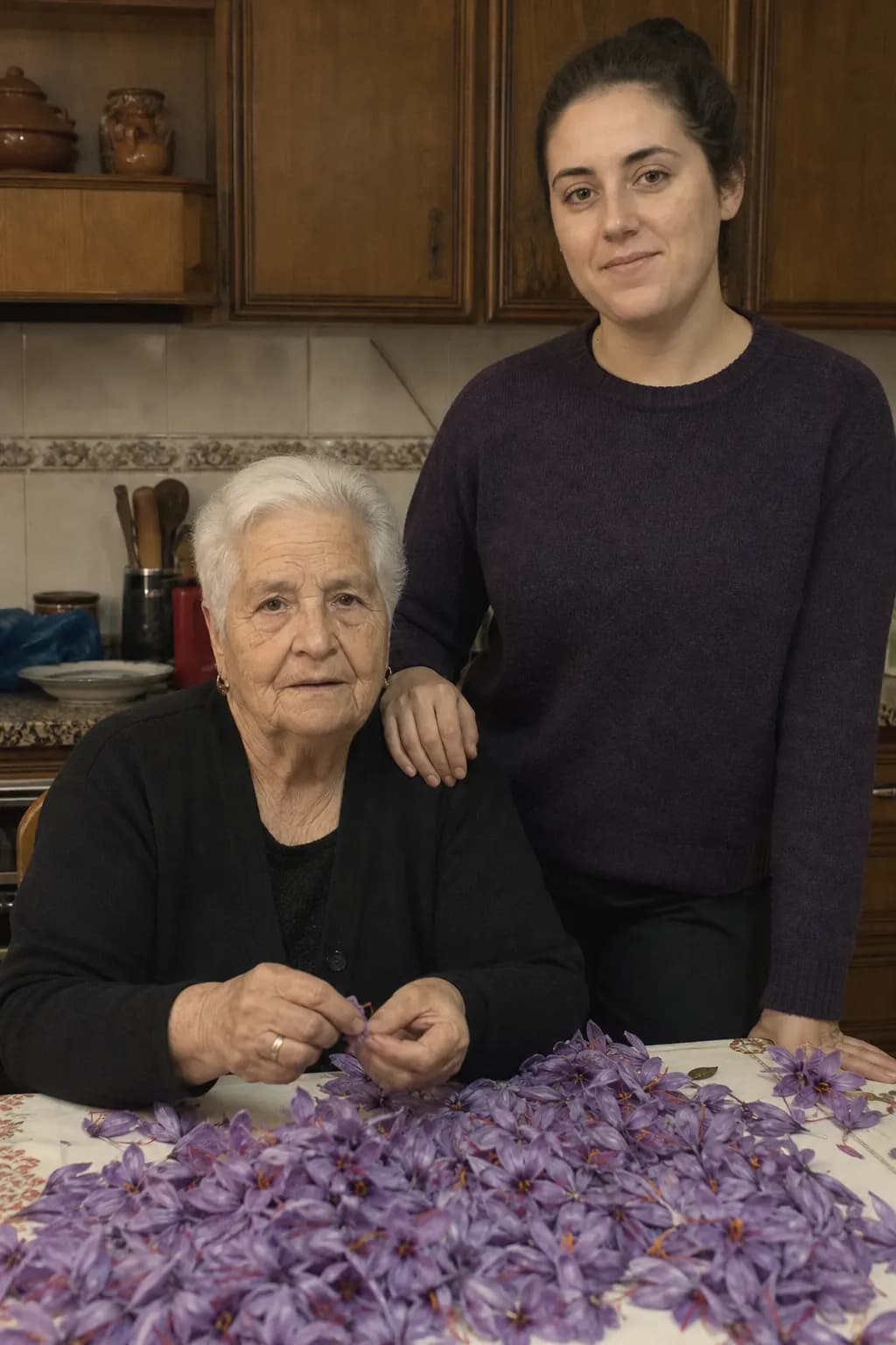 Juliana Toledano and her granddaughter Irene in a kitchen full of saffron flowers
