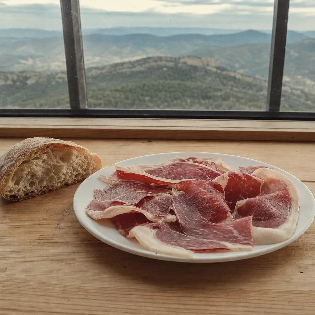 Thin slices of Teruel ham cut by hand on a white plate