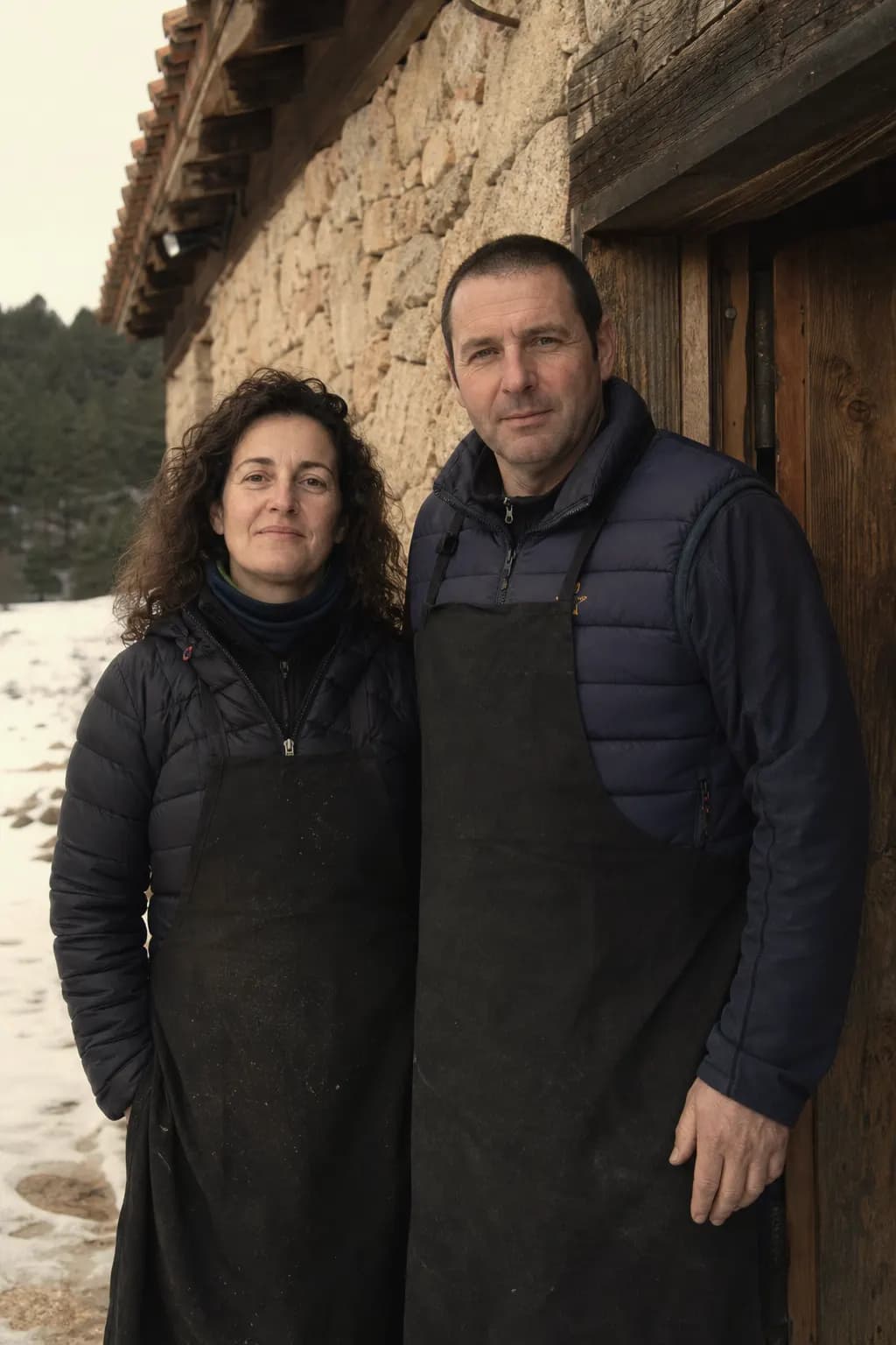 Lorena and Javi Monfort at the door of the Valdelinares drying house in the snow