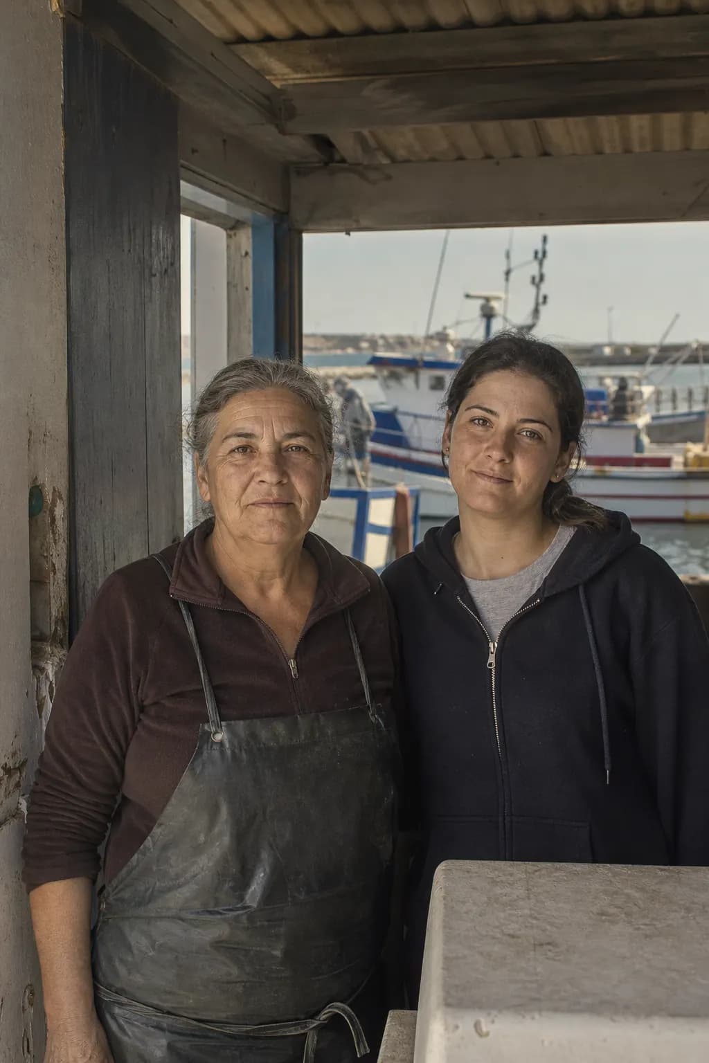 Rosa Baeza and her niece Sara at the door of their shed near Santa Pola port