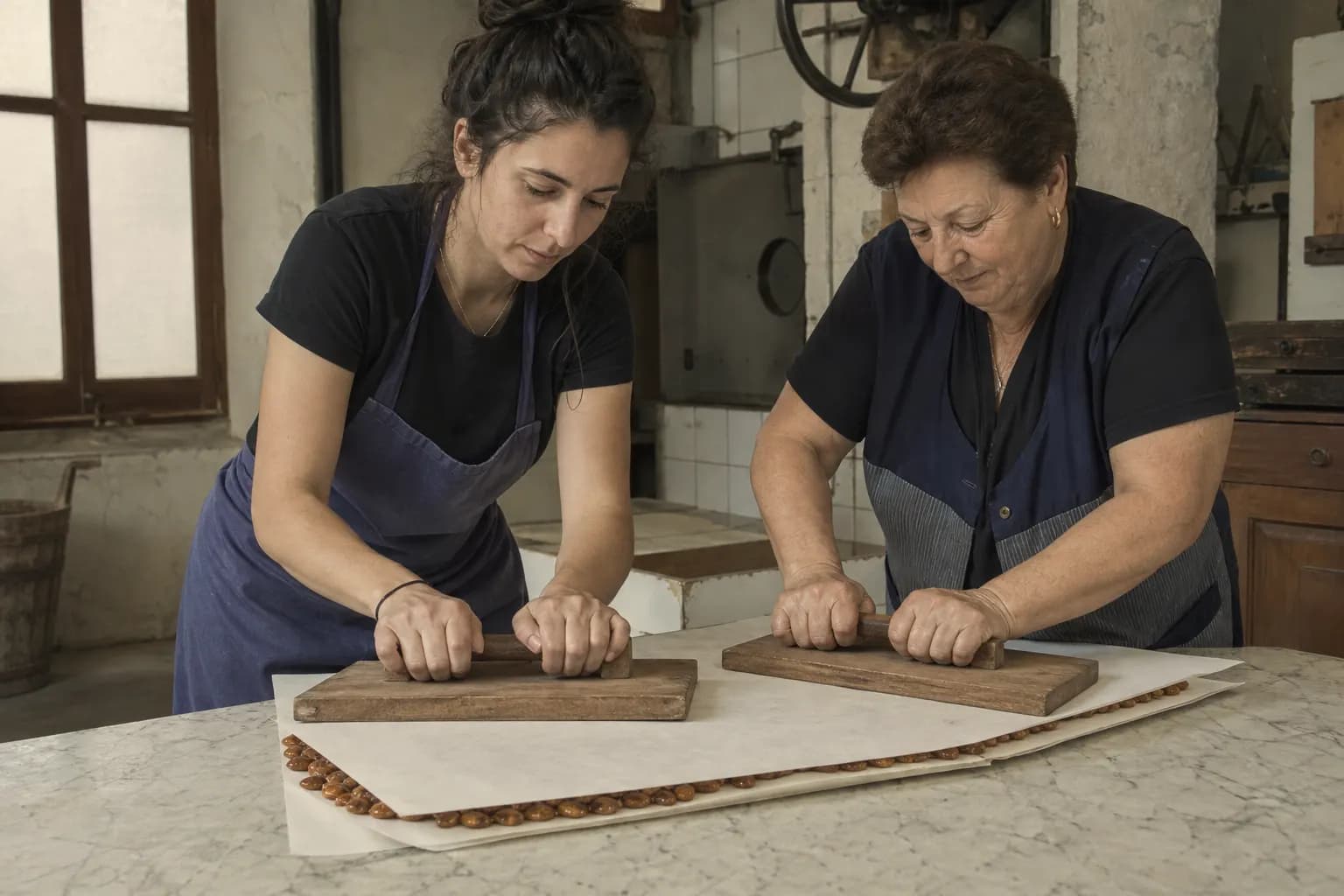 Clara Solé spreads the honey and almond mixture between two wafers