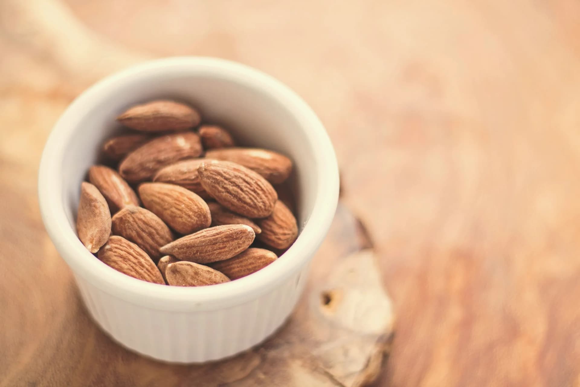Shelled almonds in a white bowl