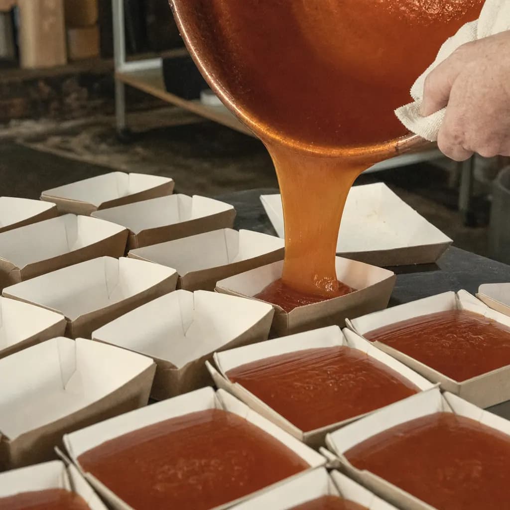 Hot quince paste poured into tubs to set